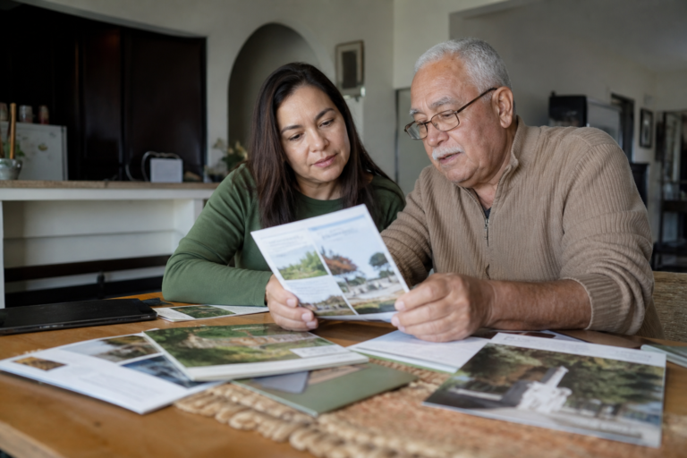 South Carolina Families: 7 Smart Ways to Plan for Funeral Costs - Adult child and elderly parent reviewing funeral planning d